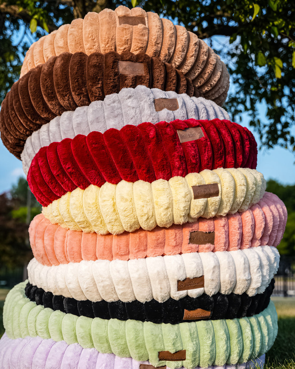 The full range of ten Hairy Housemates corduroy bed colorways stacked outdoors