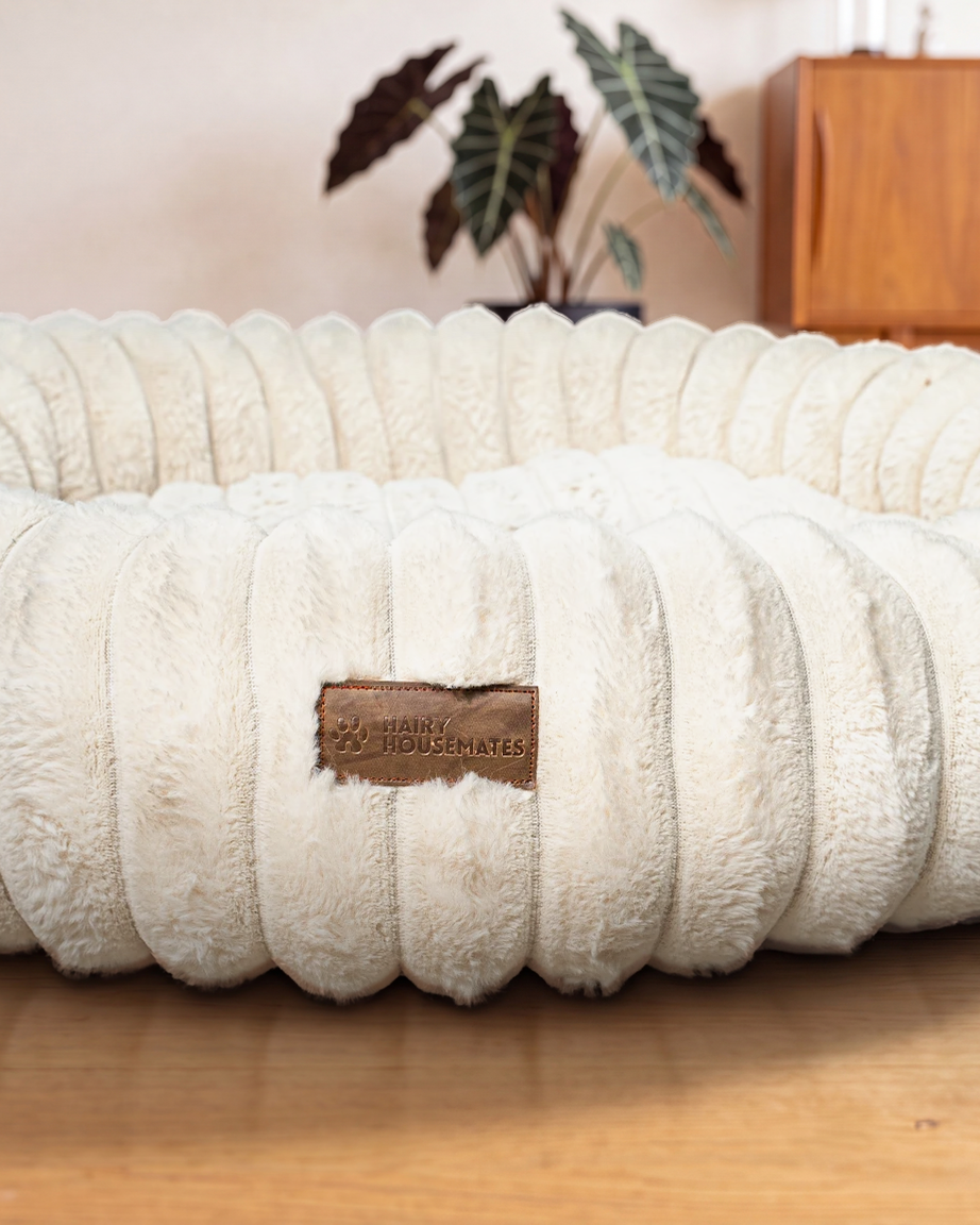 Hairy Housemates Corduroy dog bed in Ivory, on the wooden floor