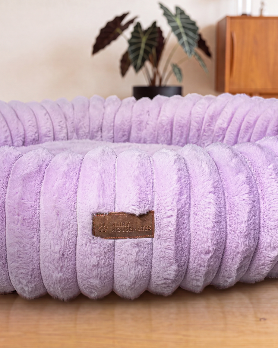 Hairy Housemates Corduroy dog bed in Lilac, on the wooden floor