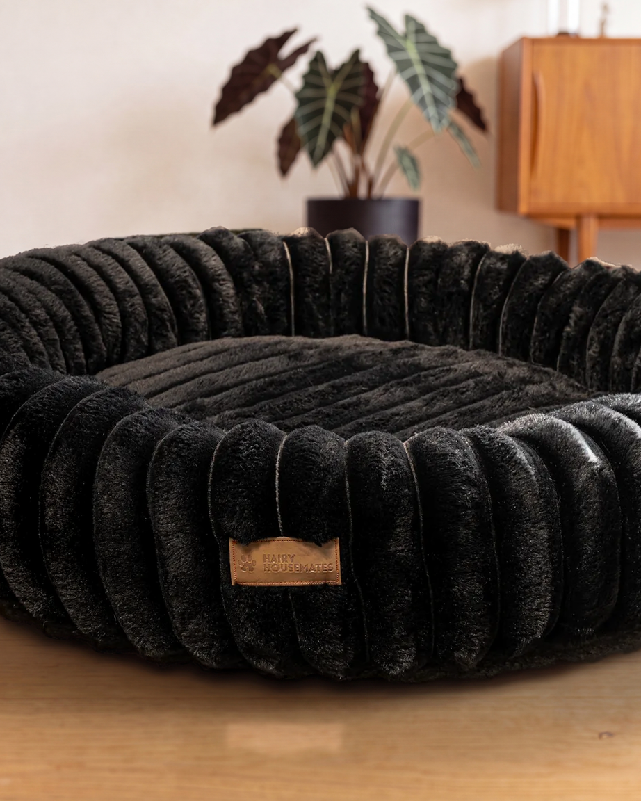 Hairy Housemates Corduroy dog bed in Onyx, on the wooden floor