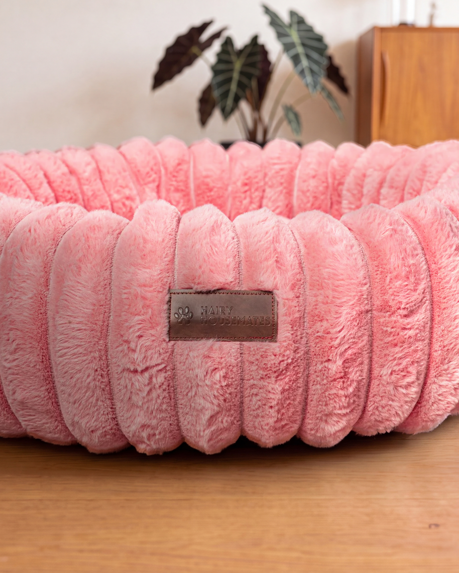 Hairy Housemates Corduroy dog bed in Rose, on the wooden floor