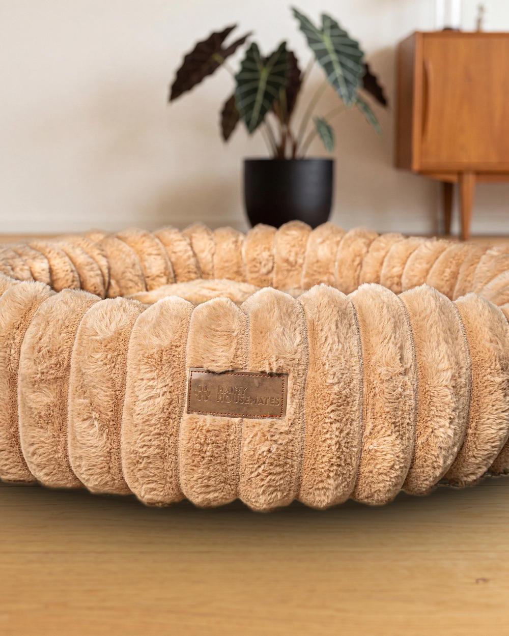Hairy Housemates Corduroy dog bed in Sand, on the wooden floor, second angle