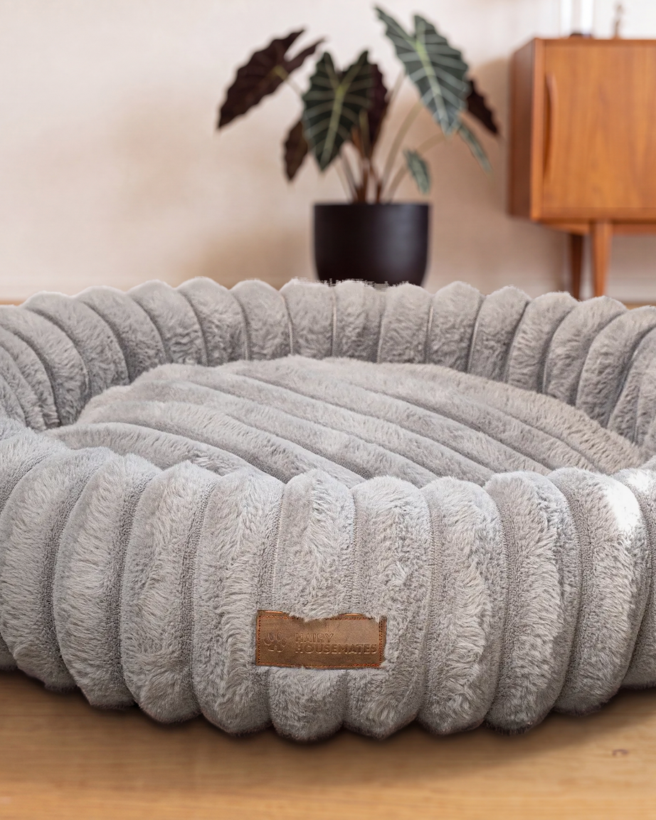 Hairy Housemates Corduroy dog bed in Slate, on the wooden floor
